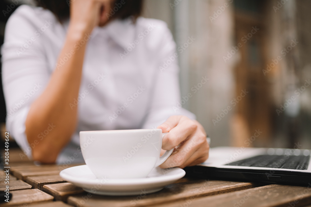 Close up of businesswoman holding cup of coffee and working outdoors. Close up of businesswoman holding cup of coffee and working outdoors.