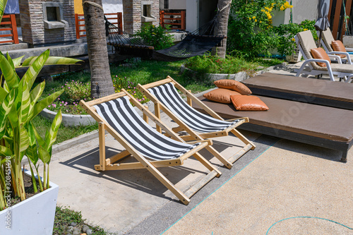 Εκτύπωση καμβά Wooden sunbeds with mattress on side of swimming pool