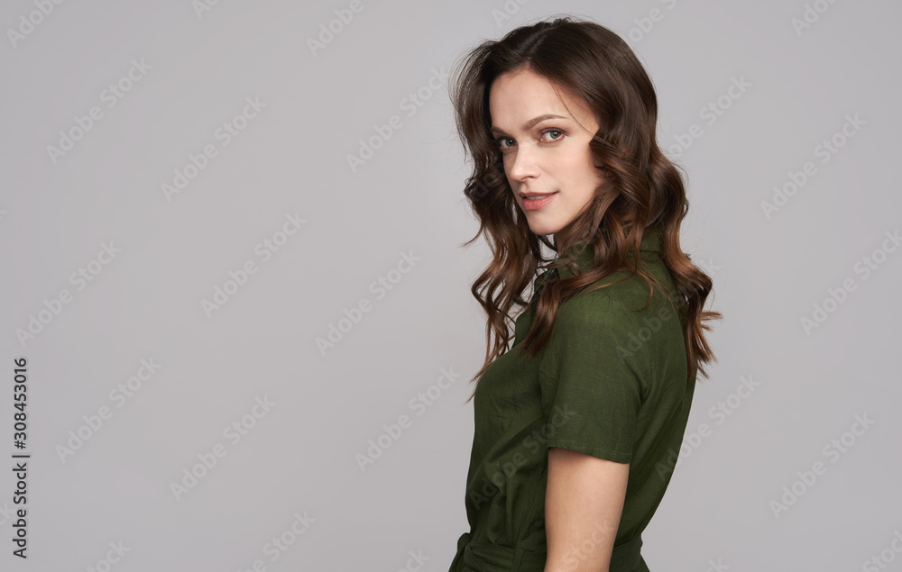 Beauty young woman in green dress is smiling. Isolated Beauty young woman in green dress is smiling. Isolated