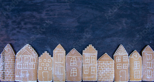 Photography tasty homemade gingerbread houses on a dark background