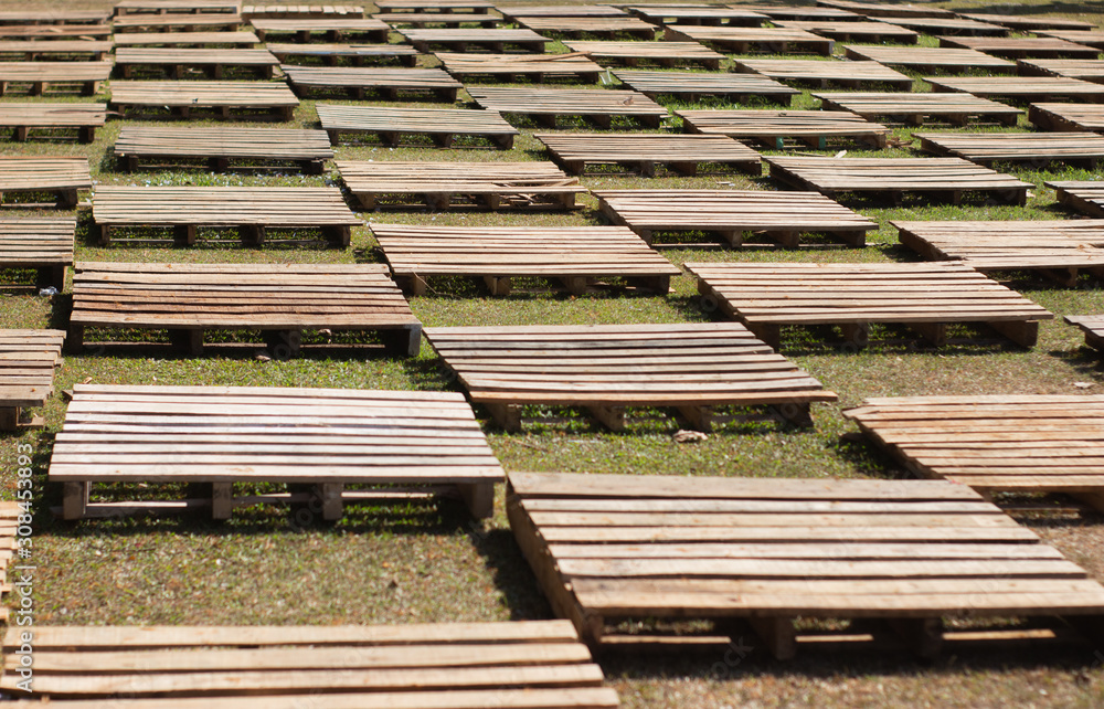 wooden blocks neatly arranged on the grass, selectively focused wooden blocks neatly arranged on the grass, selectively focused