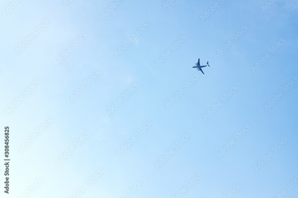 Plane flies high in blue sky from right to left Plane flies high in blue sky from right to left