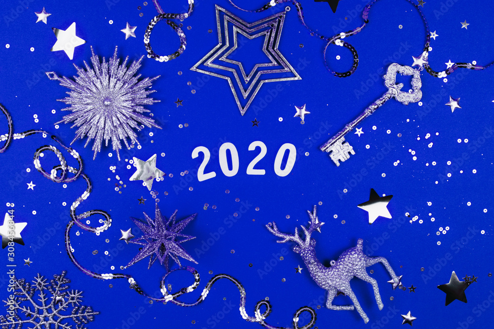 Fototapeta 2020 on blue background with sparkles. Flat lay style.