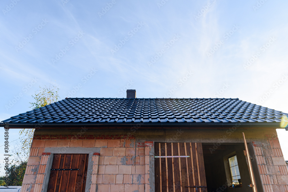 Exterior of a Unfinished Red Brick garage under Construction with roof and windows Exterior of a Unfinished Red Brick garage under Construction with roof and windows