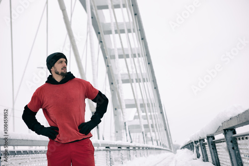 Winter running exercise, runner wearing warm clothes on break