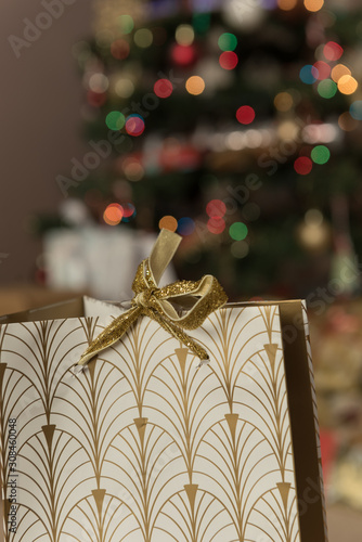 Christmas present with blurred tree in background
 photo