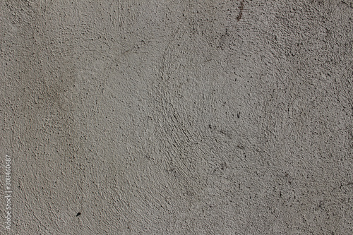 Rough curved lines on gray plaster wall