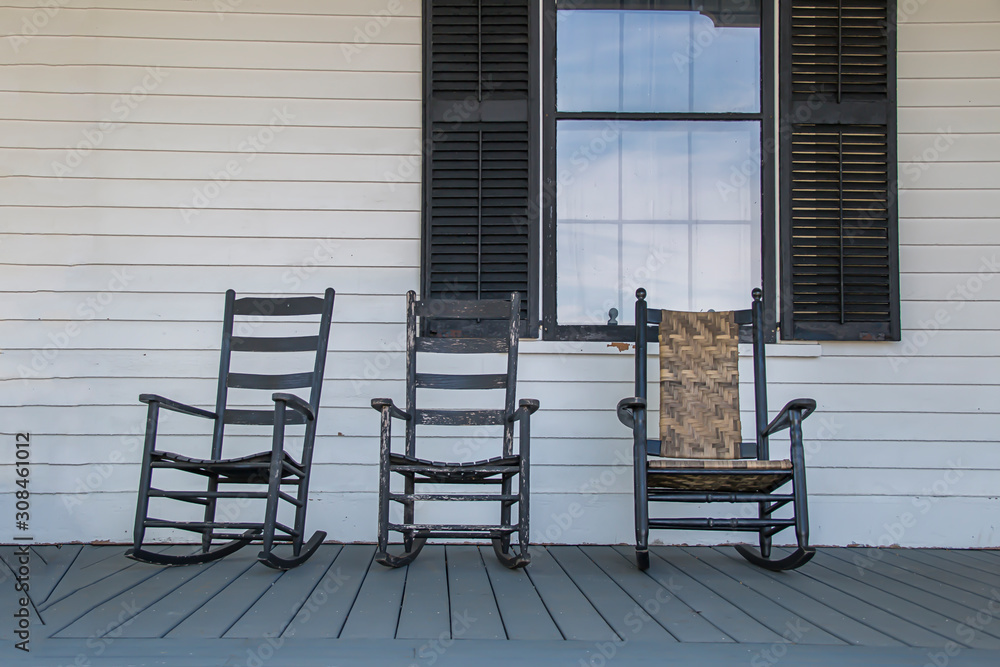Wooden rocking chairs on a front porch