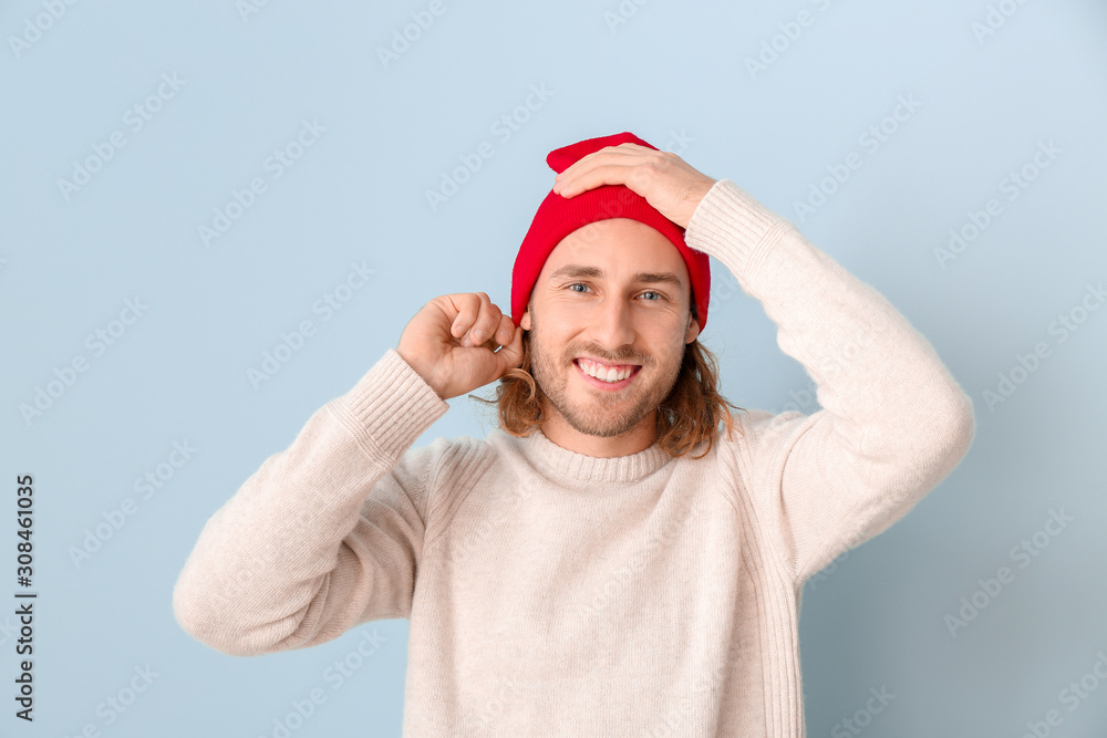 Handsome man in winter clothes on color background Handsome man in winter clothes on color background