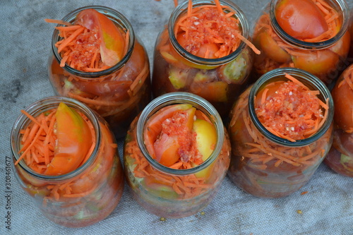 Preservation. Homemade food. Natural. Grated carrot, Red and yellow tomatoes in jars