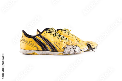 Old vintage damaged futsal sports shoes  on white background football sportware object isolated