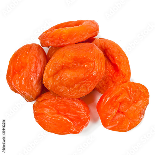 Heap of dried apricot fruits isolated on white background. Top view.