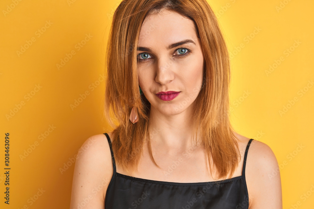 Close up of caucasian elegant woman over isolated yellow background with a confident expression on smart face thinking serious Close up of caucasian elegant woman over isolated yellow background with a confident expression on smart face thinking serious