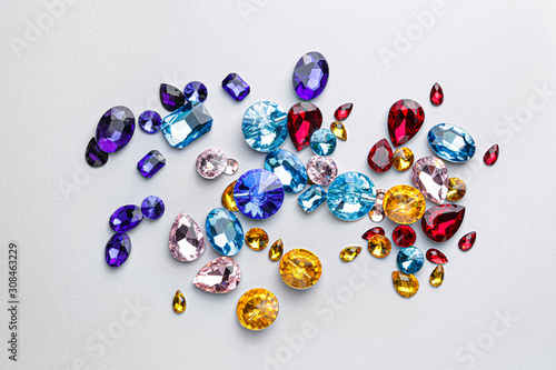 Different precious stones for jewellery on light background