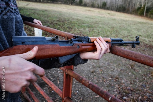 Young Generation Y or Millennial Male aged 20-30 demonstrating how to safely use a SKS firearm at an open shooting range