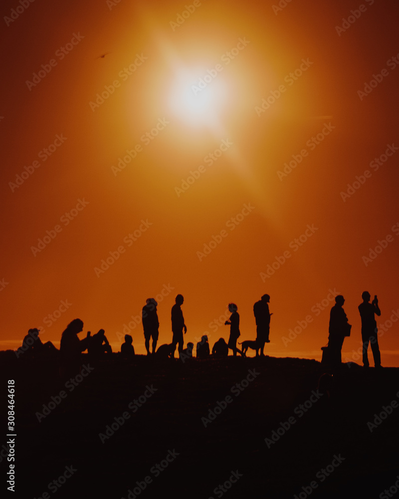 Silhouettes Of People Standing Near Cliff