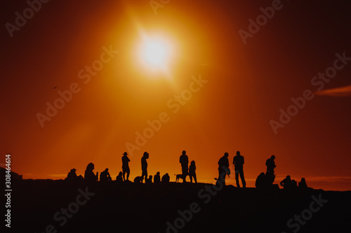 Silhouettes Of People Standing Near Cliff