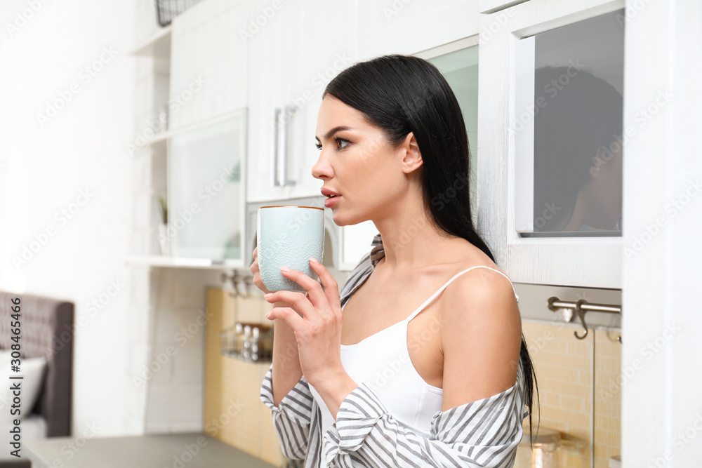 Beautiful young woman in white underwear drinking coffee at home Beautiful young woman in white underwear drinking coffee at home