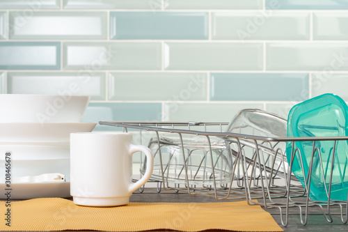 Dish rack with clean dry dishes on kitchen counter