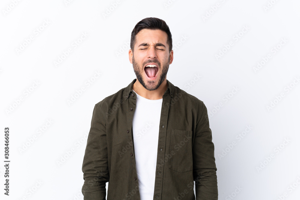 Young handsome man with beard over isolated white background shouting to the front with mouth wide open Young handsome man with beard over isolated white background shouting to the front with mouth wide open