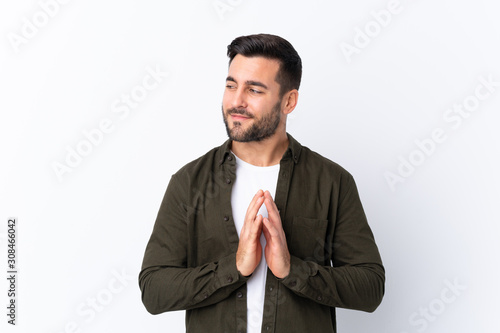 Young handsome man with beard over isolated white background scheming something