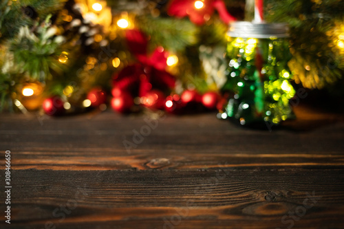 Festive christmas blurred bokeh background, wooden table with bright shiny colorful led lights bokeh, new year greeting card
