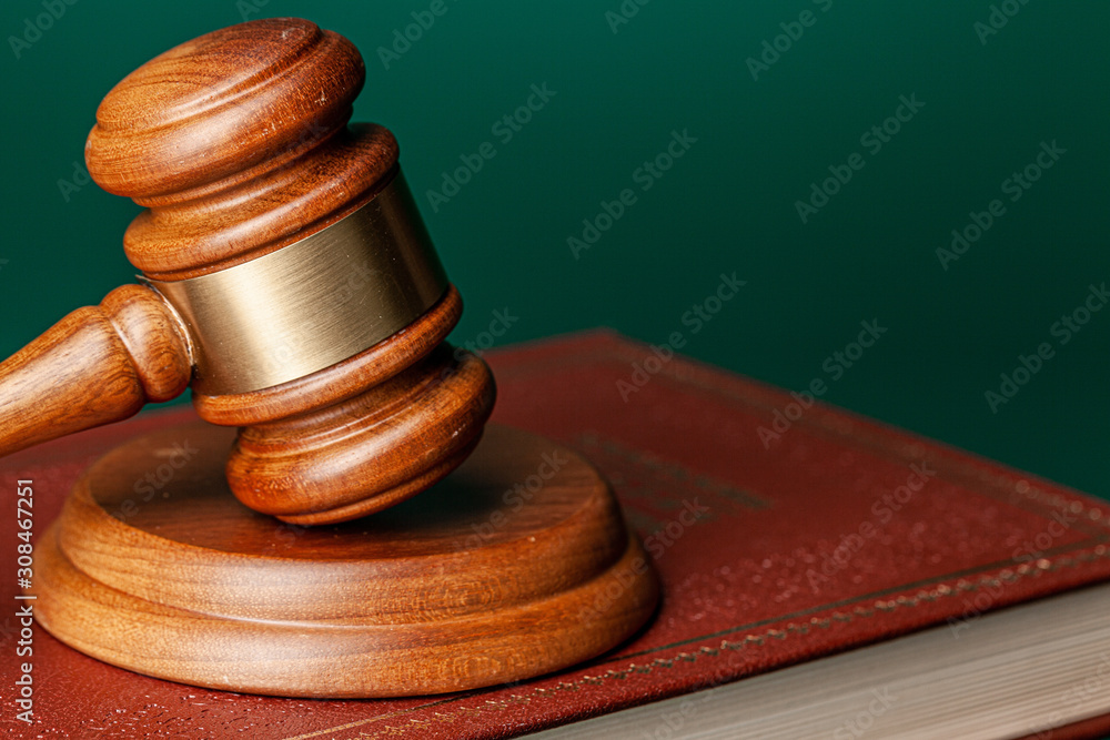 Judge gavel and legal book close up on table Judge gavel and legal book close up on table