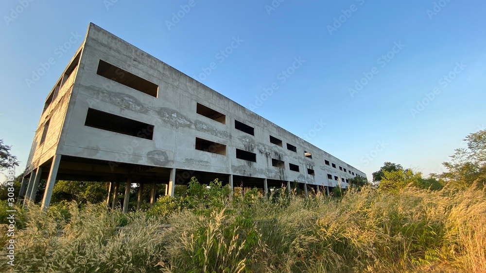 Wide scapes of deserted building and blue sky and grass. Abandoned buildings resulting in poor economic employment. Wide scapes of deserted building and blue sky and grass. Abandoned buildings resulting in poor economic employment.