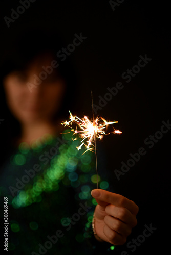Girl holds sparkler in her hands