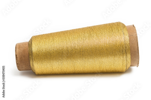 Spool of gold thread isolated on white background.