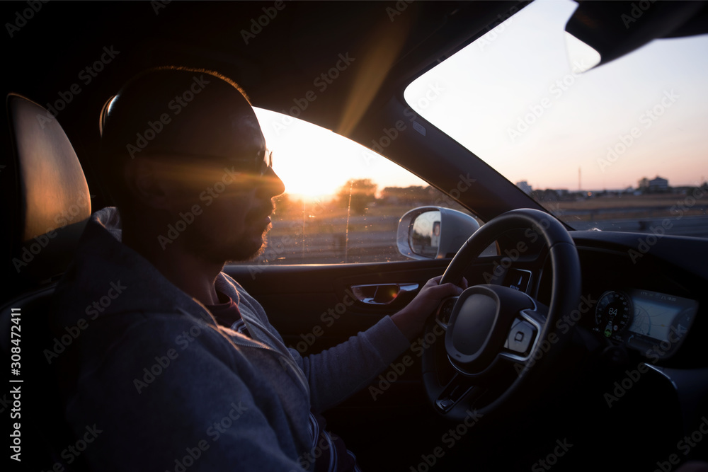 Young man driving in the modern car