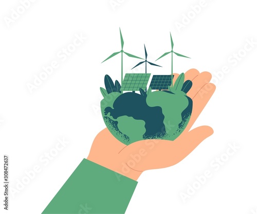 Green energy concept. Solar panels and wind turbines on planet Earth. The human hand holds a green world. Ecologically sustainable energy supply.