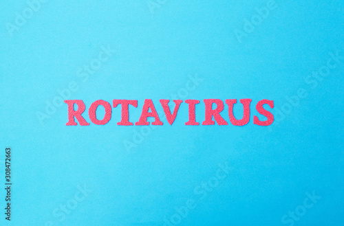 Word rotavirus made of red letters on a blue background. The concept of rotavirus infection in children and adults, intestinal flu.