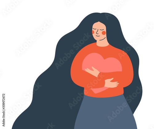 Young woman hugs a big heart with love and care. Girl with long hair holds pink heart in her hands. Self care and body positive concept.