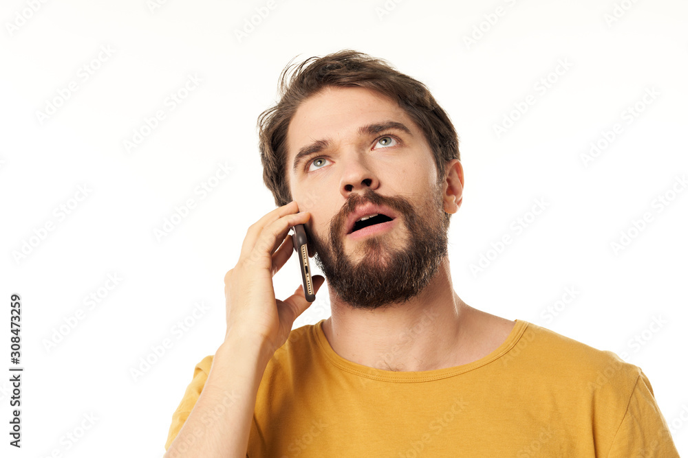 young man talking on the phone isolated on white young man talking on the phone isolated on white