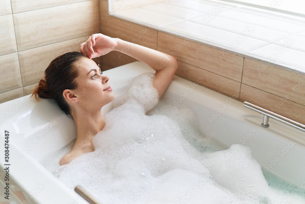 young woman relaxing in bubble bath young woman relaxing in bubble bath