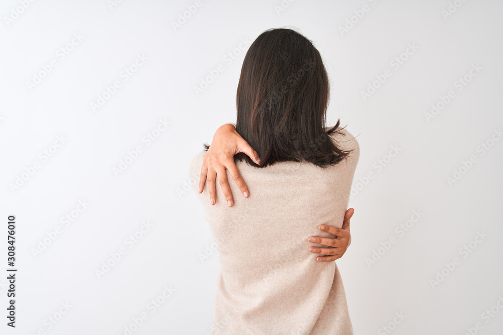 Beautiful chinese woman wearing turtleneck sweater standing over isolated white background Hugging oneself happy and positive from backwards. Self love and self care - obrazy, fototapety, plakaty 