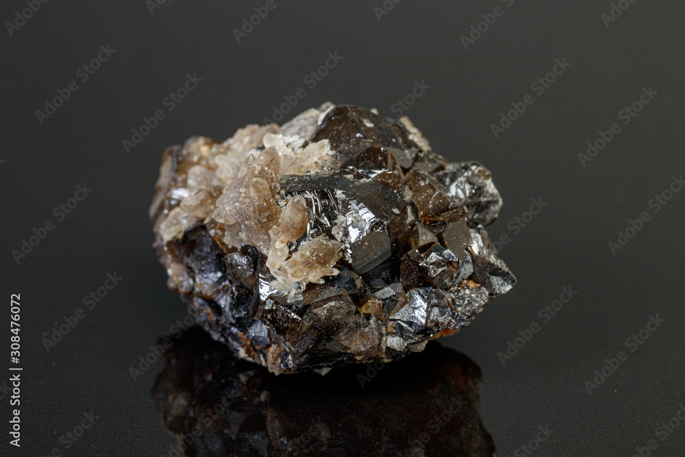 macro mineral cassiterite stone on gray background macro mineral cassiterite stone on gray background
