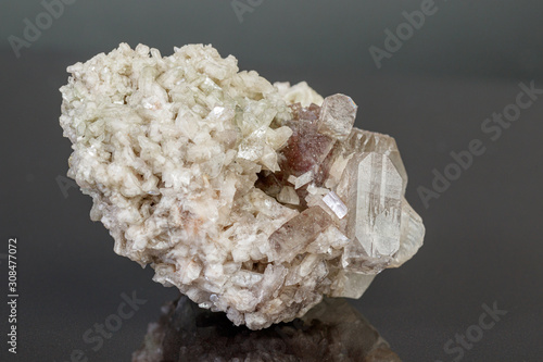 macro mineral stone Apophyllite stilbite on a gray background photo
