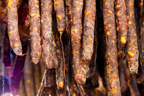 Hanging sausages in smokehouse for sale at the winter Christmas market