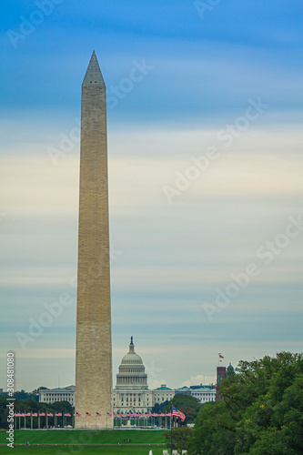 The Washington Monument with the capitol of the United States in the distance on a cloudy day.