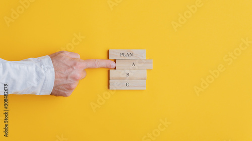 Hand of a businessman choosing a plan A option photo