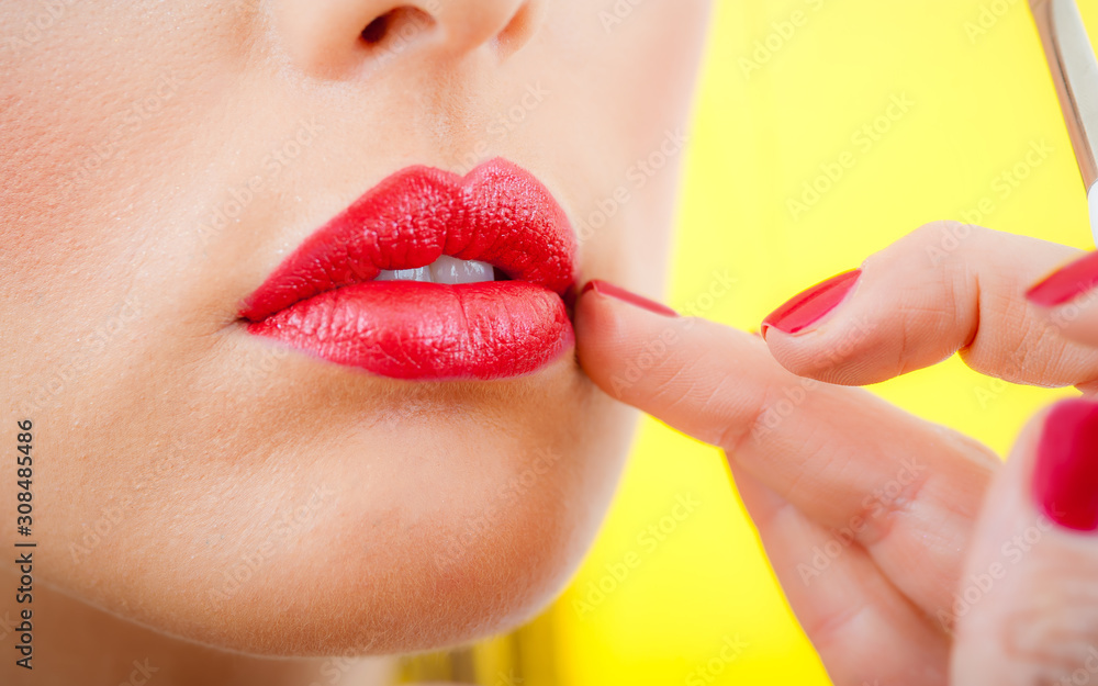 Professional lips make-up. Makeup professional artist applying lip gloss Professional lips make-up. Makeup professional artist applying lip gloss