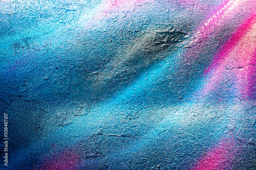 Fragment of colored graffiti painted on a wall. Bright abstract backdrop for design.