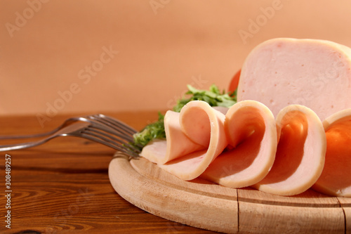 Sliced chicken ham with vegetables.