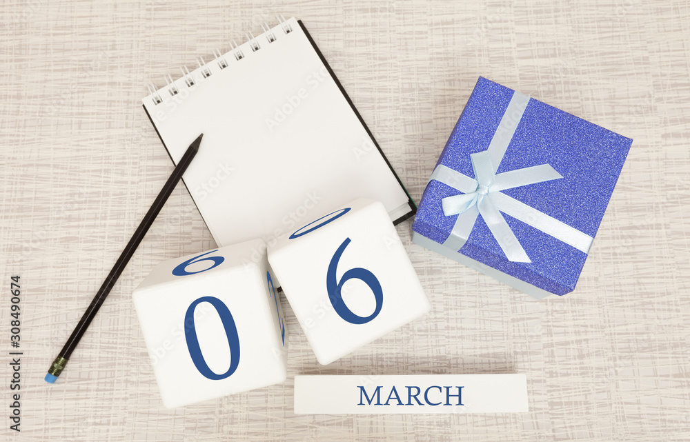 Calendar with trendy blue text and numbers for March 6 and a gift in a box.