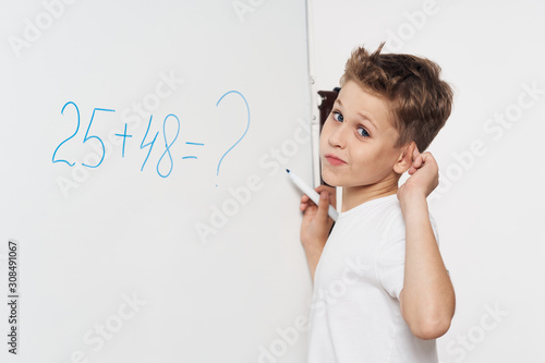 little girl writing on blackboard