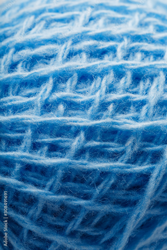 Fototapeta premium Wool yarn close-up colorful blue threads for needlework in macro.