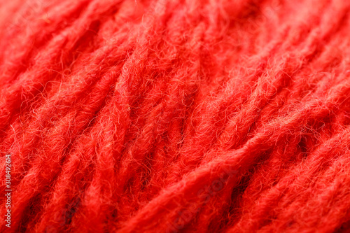 Wool yarn close-up colorful red thread for needlework in macro.