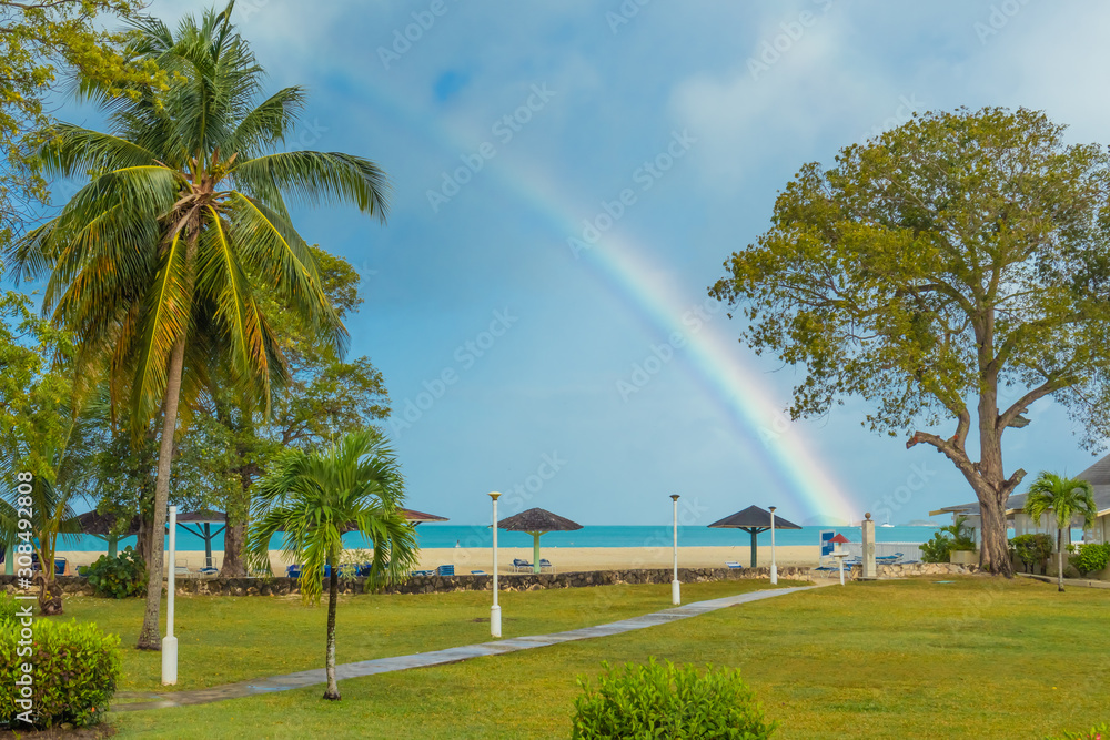Jolly Beach, St. Mary / Antigua - 04 14 2018: Rainbow over Jolly Beach, Antigua